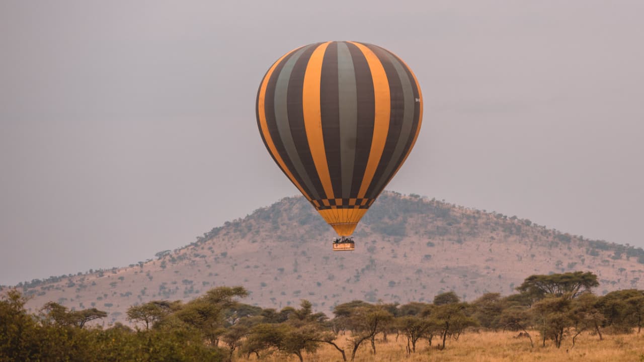 Tourists enjoying a pleasant balloon safari over the Serengeti